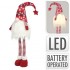 Vianočný škriatok Sneháč s LED a dlhými nohami – červený 90 cm